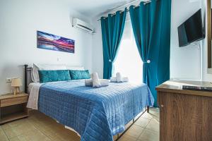 A bed or beds in a room at Basiliki's Apartments