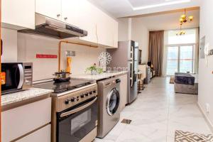a kitchen with a stove and a dishwasher at Gorgeous Burj Khalifa+CanalView in Dubai