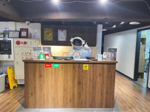 a person in a spacesuit standing at a counter at Mu Pinju Hotel in Taichung