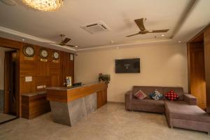 a lobby with a reception desk and a couch at RABBIT RATNAM -By Udaipur Hotels in Udaipur