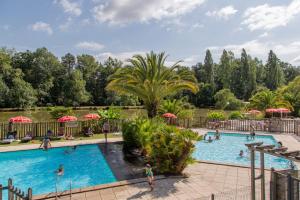 a pool at a resort with people swimming at Camping maeva Respire La Comtesse in Bélus
