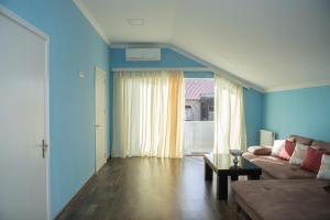 a living room with a couch and a table at Chakvi Lux House in Chakvi
