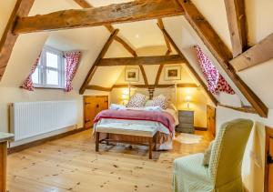 a bedroom with a bed in a attic at Orchard Cottage in East Dereham
