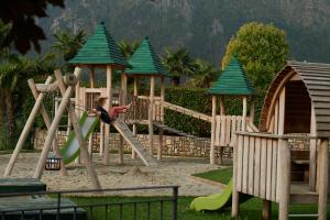 a child playing on a slide at a playground at Residence La Berna in Tremosine Sul Garda