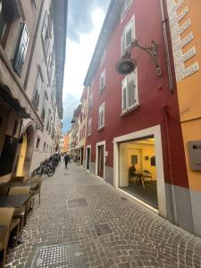 a cobblestone street in a city with buildings at Arqué Apartments - Arco Centro in Arco