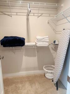 a walk in closet with shelves and towels at Cozy room in Charlottesville in Earlysville