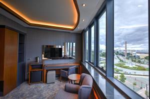 a hotel room with a desk and a television at Nova Vista Centrum Hotel Eskisehir, a Member of Radisson Individuals in Eskisehir