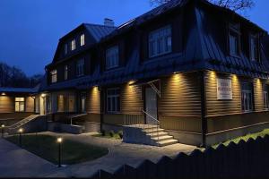 a house with lights on the front of it at Tiigi Apartment in Paide +1 photo