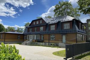 a large house with a black roof at Tiigi Apartment in Paide