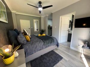1 dormitorio con 1 cama y ventilador de techo en Afrique134 Willow Tree Private Garden Suite en Pretoria