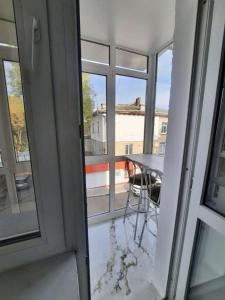 a view of a balcony with a table and a window at Centrala in Bălţi