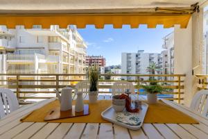 a table with a plate of food on a balcony at Apartamentos Novelty Arysal in Salou