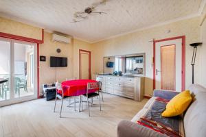 a living room with a red table and chairs at Appartement au cros de cagnes bo001 in Cagnes-sur-Mer