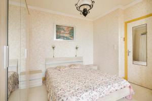 a bedroom with a bed and a chandelier at Appartement au cros de cagnes bo001 in Cagnes-sur-Mer