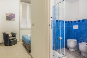 a bathroom with a shower and a bed and a toilet at Affittacamere del Golfo e delle 5 Terre in La Spezia