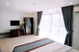 Säng eller sängar i ett rum på Song Tien Hotel