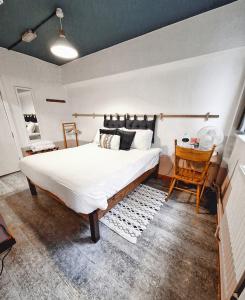a bedroom with a large bed and a table at PH Hostel Liverpool in Liverpool
