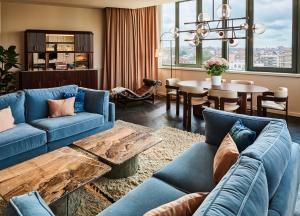 a living room with blue couches and a table at Sofitel Brussels Europe in Brussels