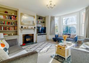 a living room with a couch and a fireplace at Alexandra Cottage in Sheringham
