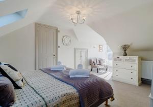 a bedroom with a bed with blue pillows on it at Alexandra Cottage in Sheringham