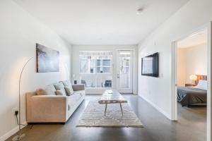 a white living room with a couch and a bed at New 2BR Luxury Apartment Hollywood in Los Angeles
