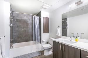 a bathroom with a shower and a toilet and a sink at New 2BR Luxury Apartment Hollywood in Los Angeles