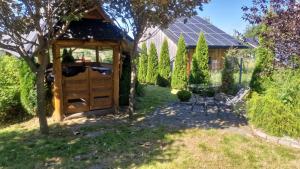 a wooden shed in a yard with a table at Bukowiański Dworek in Bukowina Tatrzańska