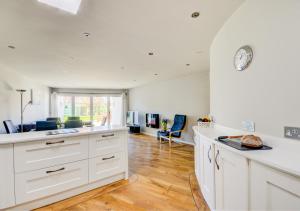 a kitchen with white cabinets and a counter top at The Eye in Sheringham