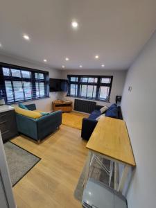 a living room with a couch and a table at Town Centre Modern 1 Bed self-contained Apartment in Newbury