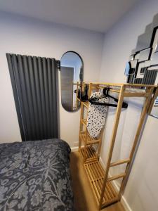 a bedroom with a bunk bed and a mirror at Town Centre Modern 1 Bed self-contained Apartment in Newbury