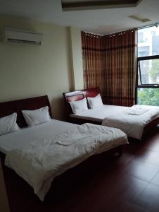 Кровать или кровати в номере Nhà nghỉ Thành Đạt