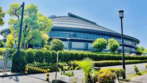 a building with a lot of bushes in front of it at Toyoko Inn Hiroshima-eki Minami-guchi Migi in Hiroshima