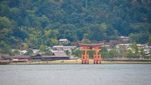 an orange gate in the middle of a body of water at Toyoko Inn Hiroshima-eki Minami-guchi Migi in Hiroshima