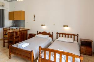 A bed or beds in a room at Irene Hotel Leros
