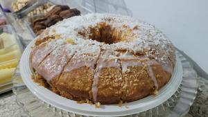 a cake on a plate on a glass table at Hotel Calema in Capitão Leônidas Marques