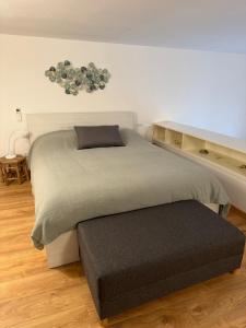 a bedroom with two beds and a ottoman at Cala Gavetta mezzanine studio in La Maddalena