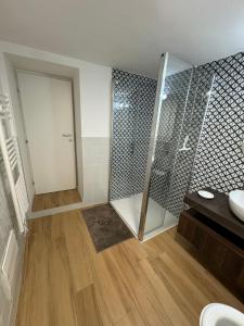 a bathroom with a shower and a sink at Cala Gavetta mezzanine studio in La Maddalena
