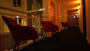 a row of chairs sitting on a balcony at night at Schlosshotel Rheinsberg in Rheinsberg