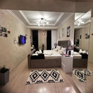 a bedroom with a large bed and a living room at Houses for COP29 in Baku