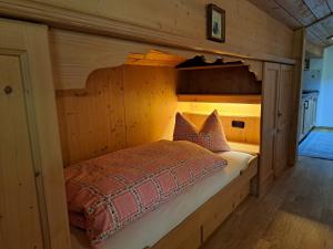 a bedroom with a bed in a wooden cabin at Haus Sunnleitn Vogelsang in Bayrischzell