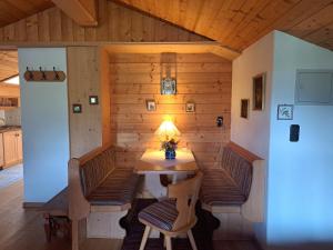 a room with a table and chairs in a house at Haus Sunnleitn Vogelsang in Bayrischzell