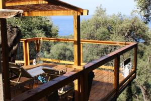 a deck with a view of the ocean from a house at Nature Habitat and Artistic Room in Pentátion