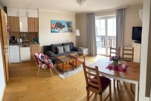 a living room with a couch and a dining room table at Wallner am See in St. Wolfgang