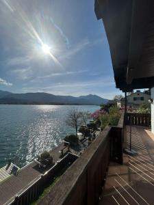 a view of a body of water with the sun shining at Wallner am See in St. Wolfgang