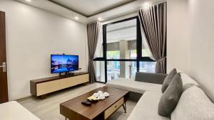 a living room with a couch and a tv at Wins Apartment in Hanoi