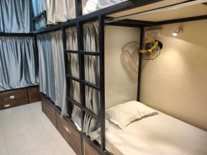 a bunk bed in a room with windows at Royal Guest House in Varanasi