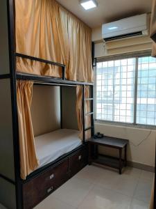 a bunk bed in a room with a window at Royal Guest House in Varanasi
