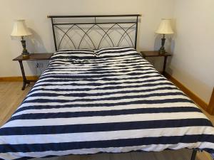 a black and white striped bed in a bedroom at The Cellar on Hornby in Morecambe