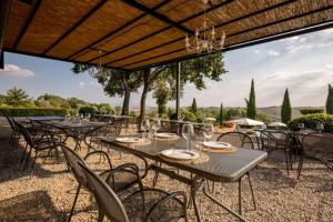 a group of tables and chairs with a view at Villa Asciano 20 by Mmega in Trequanda +37 photos
