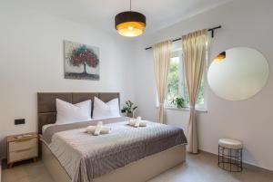 a bedroom with a bed with two towels on it at Luxury Apartments Blue Moon - New Apartments in Slano